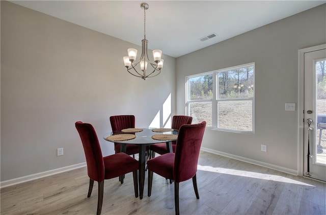 dining room featuring a chandelier and light hardwood / wood-style flooring