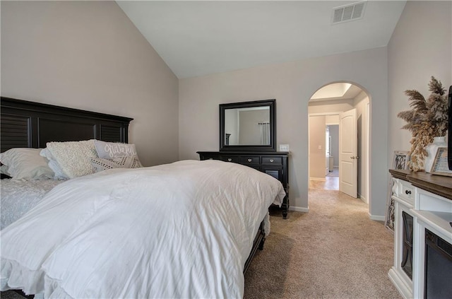 bedroom featuring vaulted ceiling and light carpet