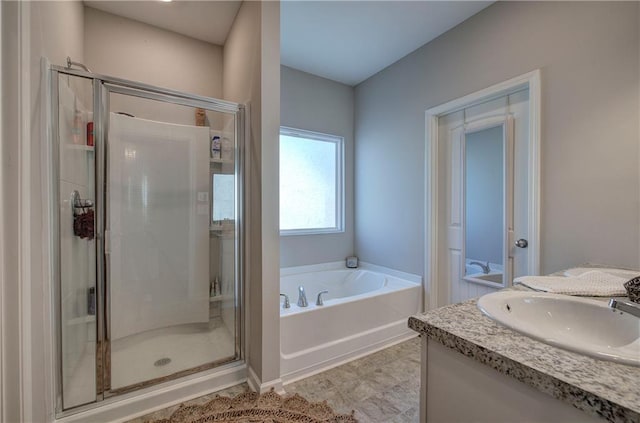 bathroom with vanity and independent shower and bath