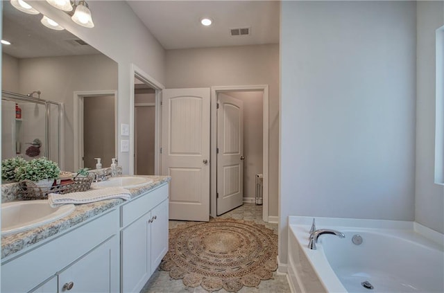 bathroom with vanity, tile patterned flooring, and shower with separate bathtub