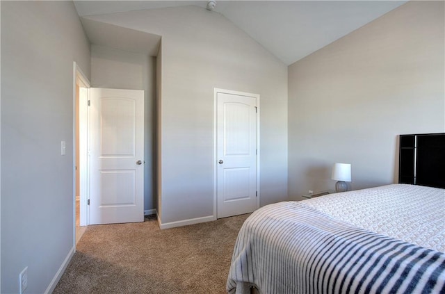 carpeted bedroom with vaulted ceiling