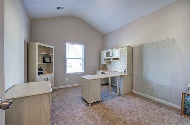 carpeted office space with lofted ceiling