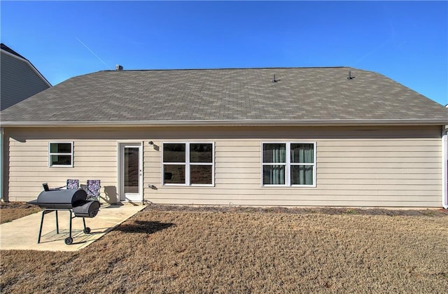 rear view of property with a patio area and a lawn