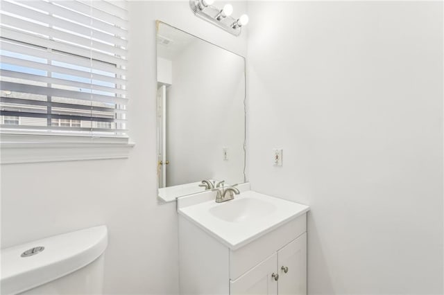 bathroom featuring toilet and vanity