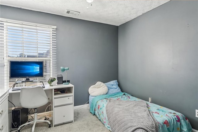 bedroom with a textured ceiling, baseboards, visible vents, and light colored carpet