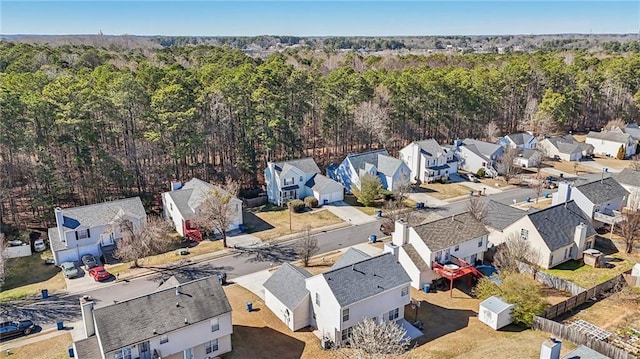 birds eye view of property featuring a residential view and a wooded view