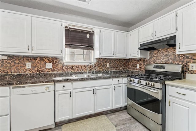 kitchen featuring white cabinets, dishwasher, stainless steel range with gas stovetop, under cabinet range hood, and a sink