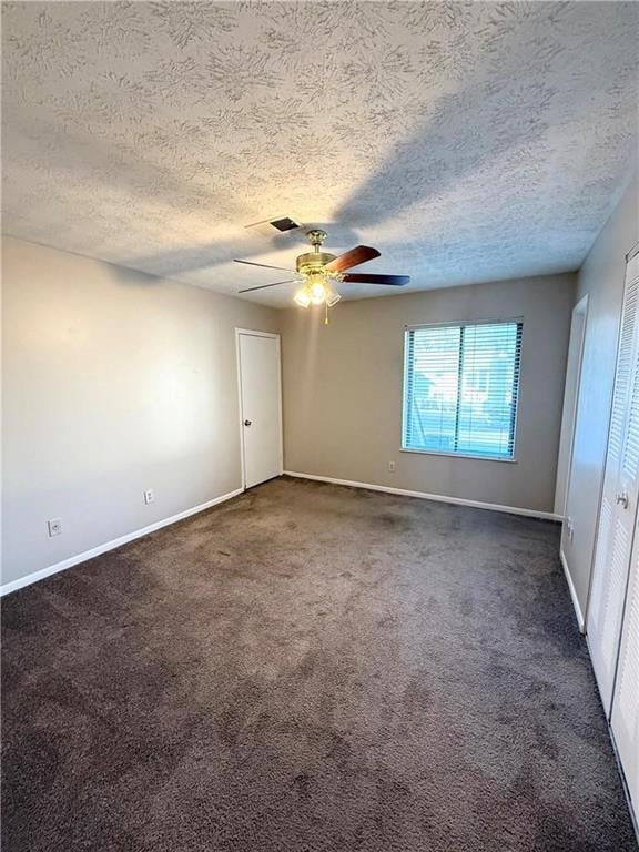 296 Country Club Dr, Jonesboro, GA 30238 - empty room with dark carpet, baseboards, ceiling fan, and a textured ceiling