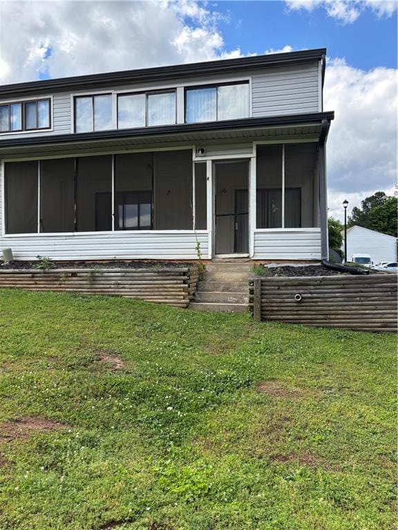 296 Country Club Dr, Jonesboro, GA 30238 - view of front of home featuring a sunroom and a front lawn