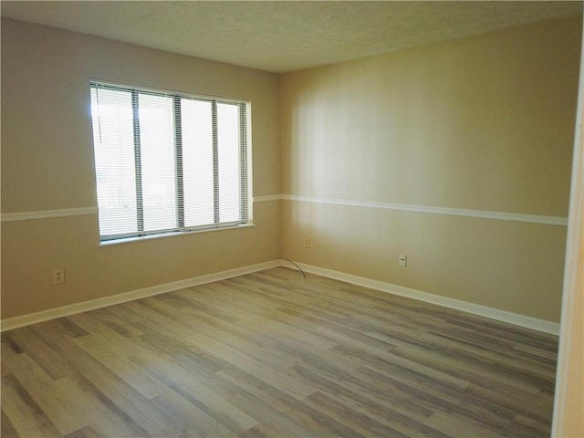 296 Country Club Dr, Jonesboro, GA 30238 - unfurnished room with wood finished floors, baseboards, and a textured ceiling