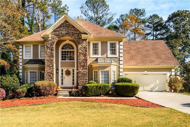 view of front of home featuring an attached garage, a front lawn, concrete driveway, and stucco siding