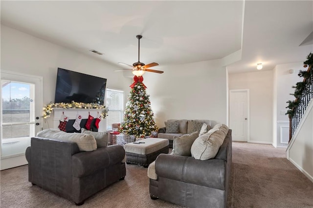 carpeted living room featuring ceiling fan and a healthy amount of sunlight