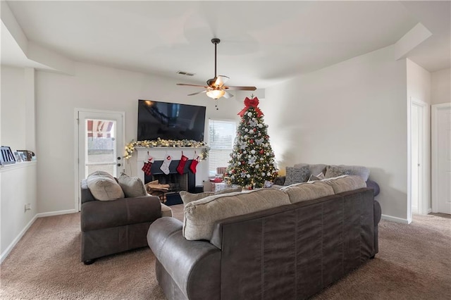 living room with ceiling fan, plenty of natural light, and carpet