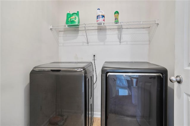 laundry area with washing machine and clothes dryer