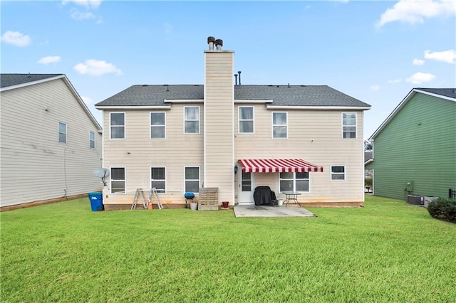 rear view of house with a lawn, a patio, and central AC unit