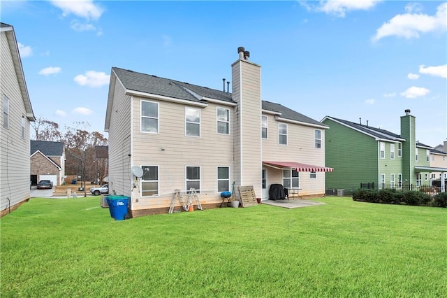 back of house with a yard and a patio