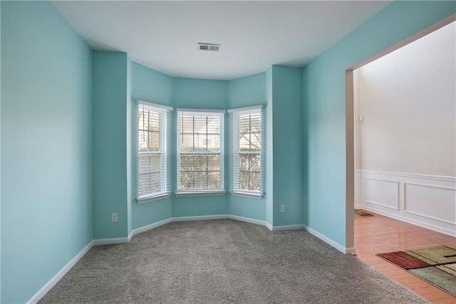 empty room featuring light colored carpet