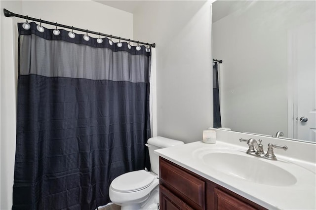 bathroom featuring walk in shower, vanity, and toilet