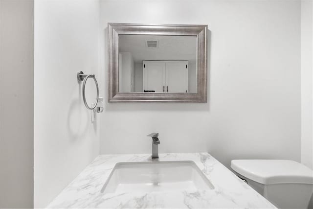 bathroom featuring vanity and toilet