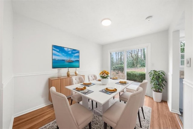 dining area with light hardwood / wood-style flooring and a wealth of natural light