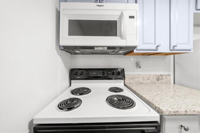 kitchen with light stone counters, white cabinets, decorative backsplash, and electric range