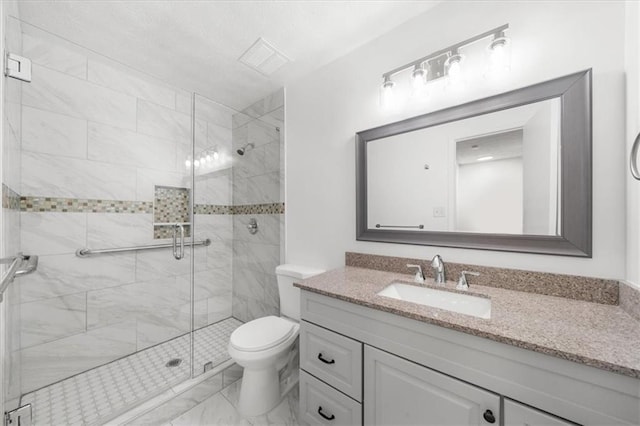 bathroom featuring vanity, an enclosed shower, and toilet