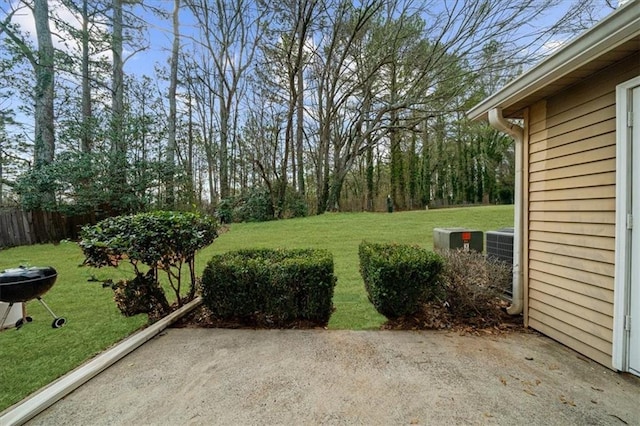 view of yard with central AC unit and a patio