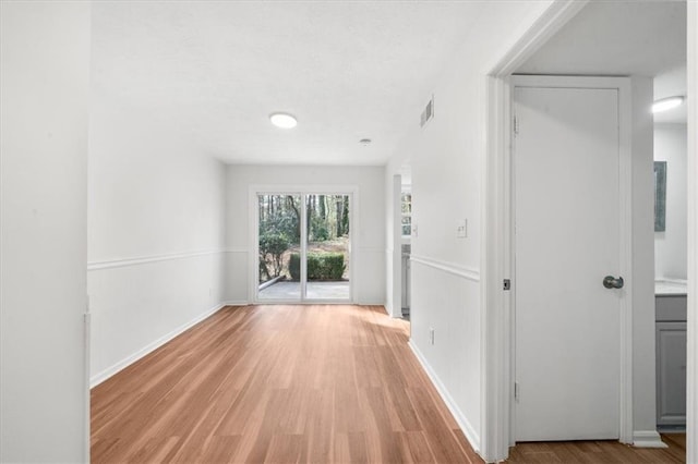 hall with light hardwood / wood-style flooring