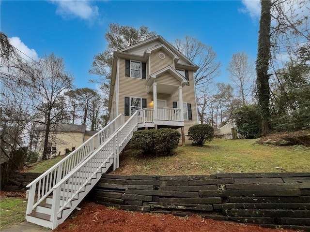 view of front of home with a front yard and stairs