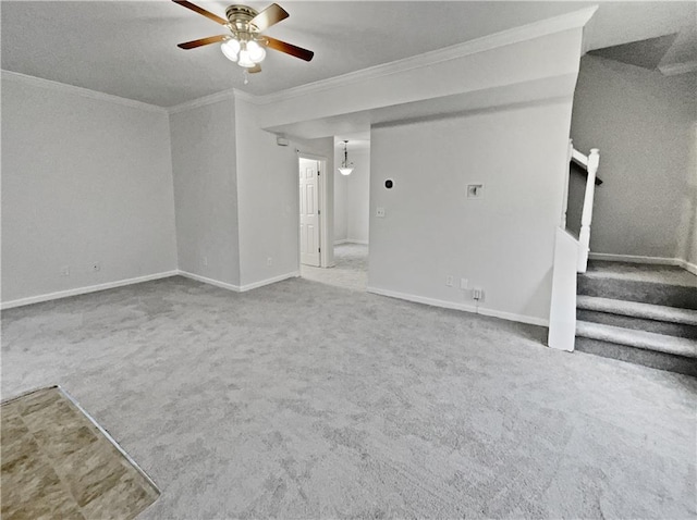 unfurnished living room with crown molding, baseboards, stairway, carpet floors, and a ceiling fan