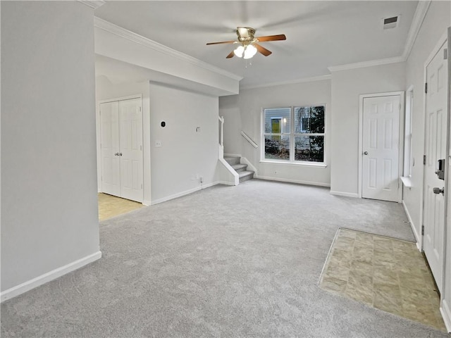 unfurnished living room with visible vents, baseboards, stairs, ornamental molding, and carpet floors