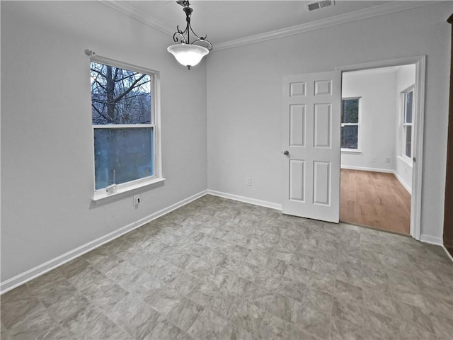 spare room with visible vents, baseboards, and ornamental molding