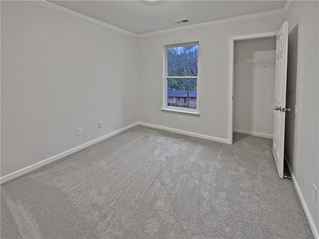 unfurnished bedroom with baseboards, visible vents, carpet floors, and ornamental molding