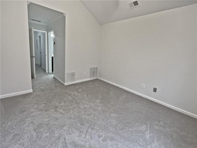 empty room with visible vents, baseboards, and dark carpet