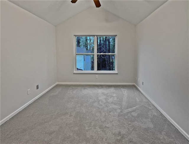 spare room with lofted ceiling, carpet flooring, baseboards, and ceiling fan