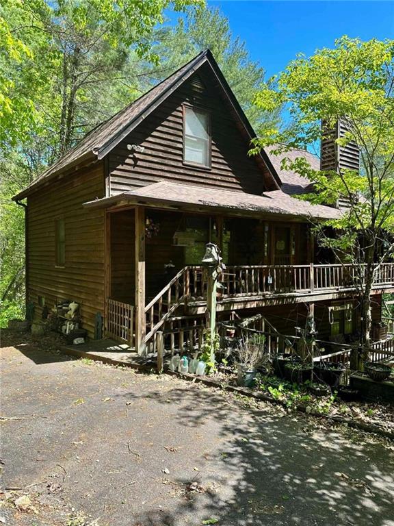 log cabin featuring a porch