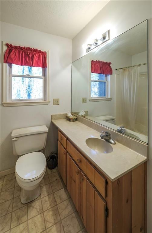 full bath with toilet, a textured ceiling, and vanity