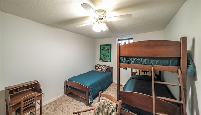 carpeted bedroom with baseboards, a ceiling fan, and a textured ceiling