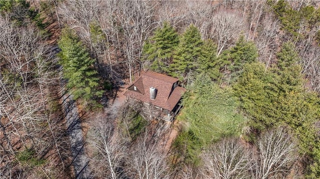 drone / aerial view with a wooded view