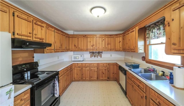 kitchen with under cabinet range hood, white appliances, a sink, light countertops, and light floors