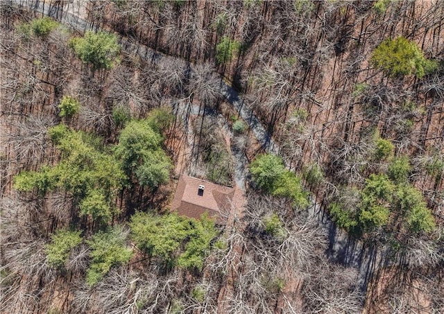 birds eye view of property with a view of trees