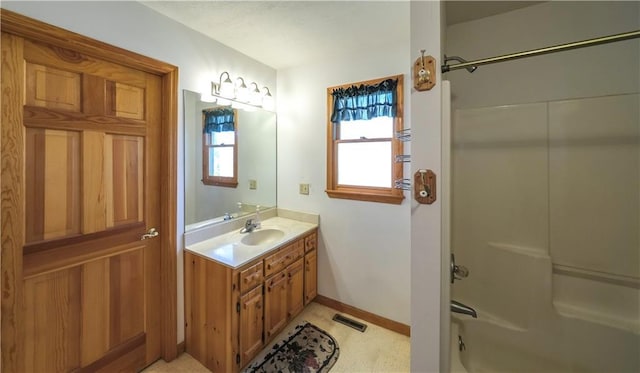 bathroom featuring visible vents, shower / tub combination, baseboards, and vanity