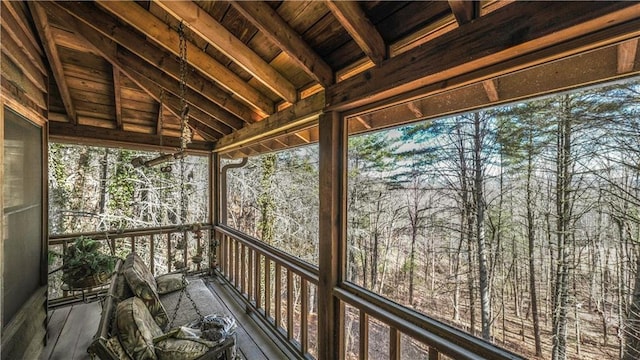 unfurnished sunroom with wooden ceiling and vaulted ceiling