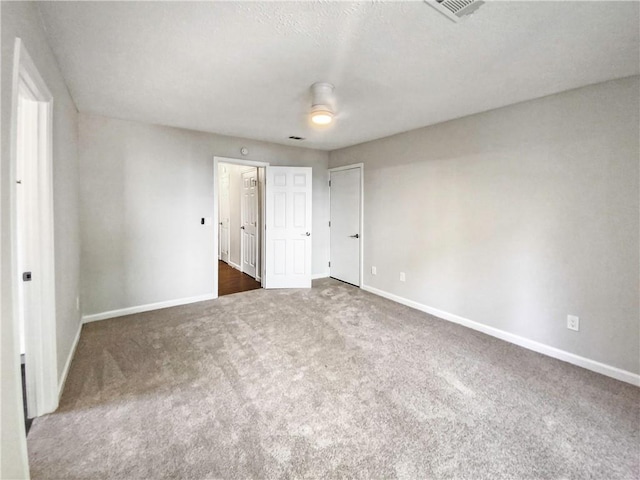 unfurnished bedroom with dark colored carpet and ceiling fan