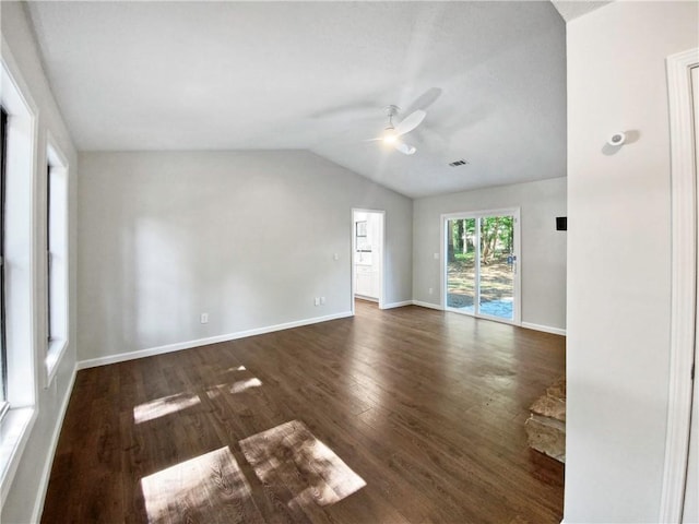 spare room featuring vaulted ceiling, ceiling fan, and dark wood-type flooring