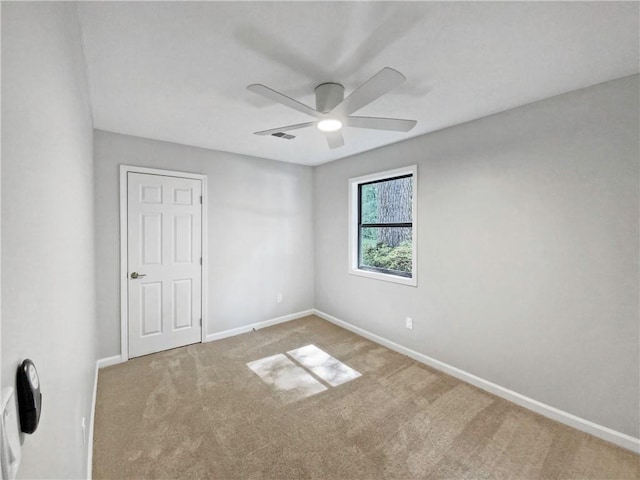 carpeted empty room featuring ceiling fan