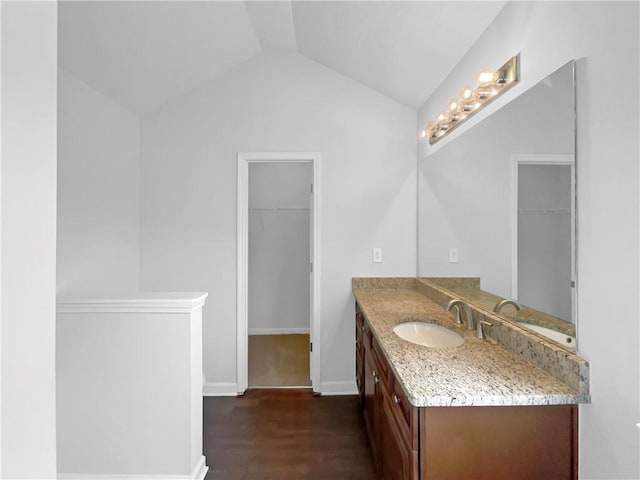 2397 Charleston Ter, Decatur, GA 30034 - bathroom featuring vanity, a spacious closet, wood finished floors, vaulted ceiling, and baseboards