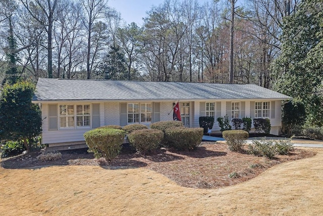 ranch-style house featuring brick siding