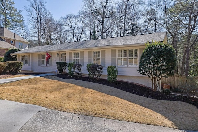 ranch-style house with fence and a front yard