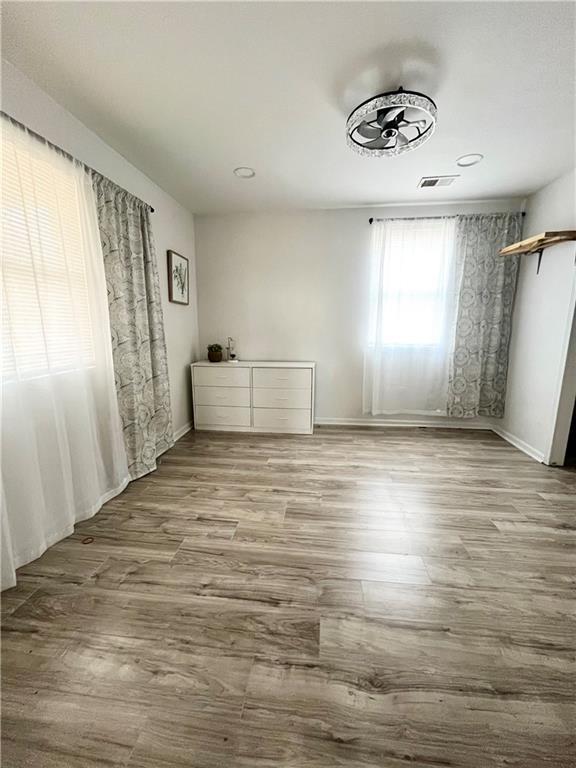 unfurnished bedroom with light wood-type flooring